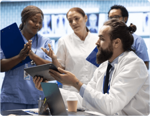 Healthcare professionals reviewing patient information on a tablet